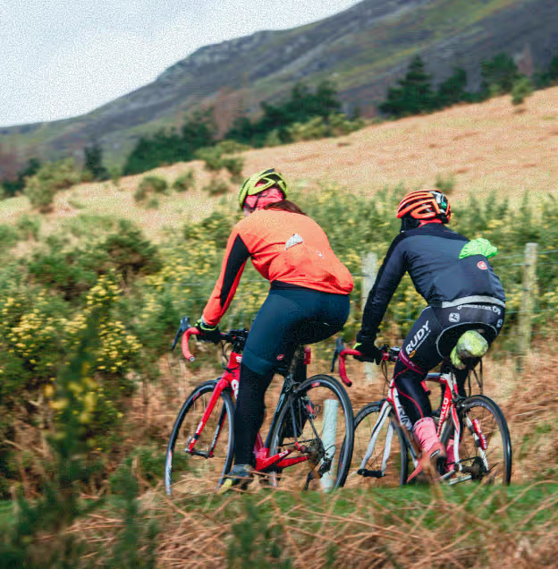 Two people riding bike in mountains